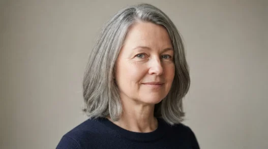 52-year-old woman with round face and mid-length greying disconnected lob past jaw in soft studio light